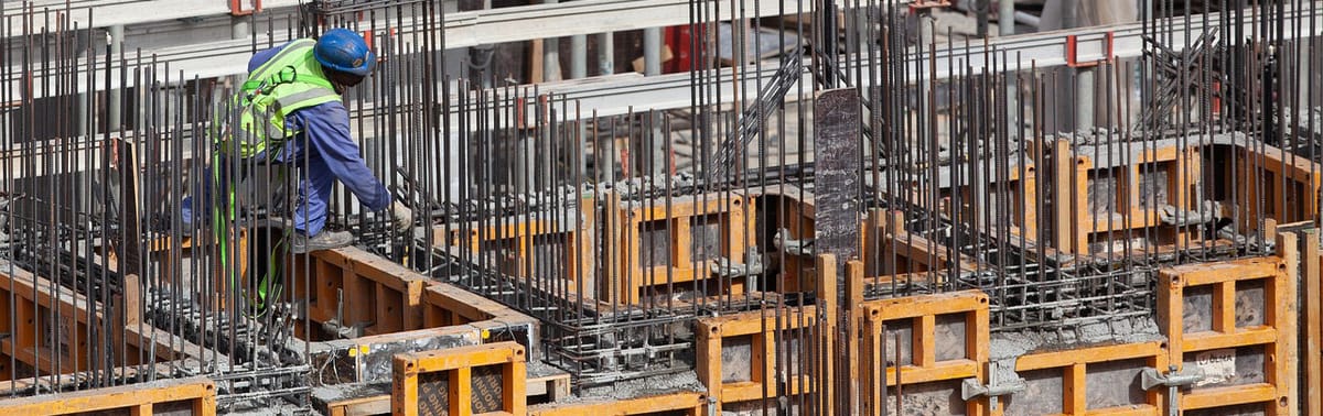 A construction worker building a wall